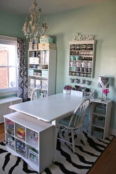 a white table and chairs in a room with zebra print rugs on the floor