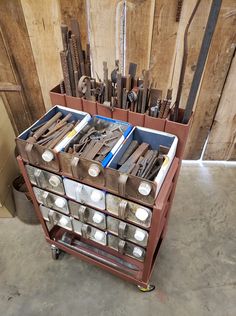 a cart filled with lots of tools on top of a floor