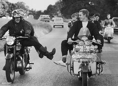 black and white photograph of men riding motorcycles