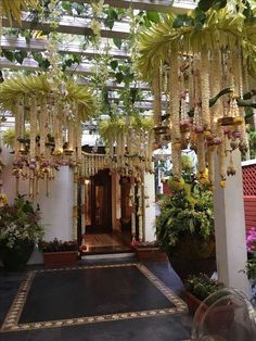 the entrance to a building decorated with hanging flowers