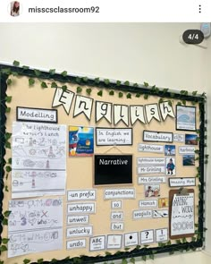 a bulletin board with writing and pictures on the front, surrounded by green ivys