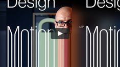 an image of a man with glasses looking out from behind a wall that says design