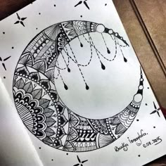 a drawing of a crescent moon with drops of water hanging from it's side