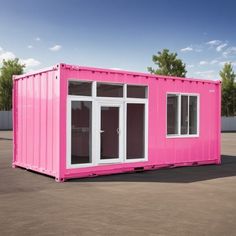 a pink shipping container sitting on top of a parking lot next to a building with windows