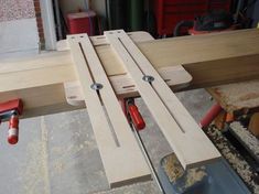 a couple of pieces of wood sitting on top of a wooden table next to some tools