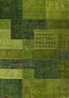 a patchwork rug with many different colors and patterns on it, including green tones