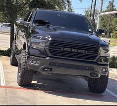 a black ram truck parked in a parking lot