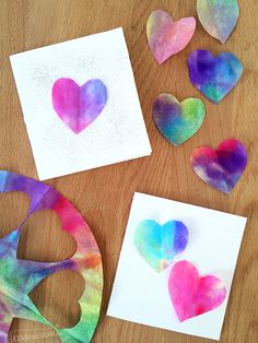 paper hearts are cut out and placed on the table