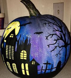 a painted pumpkin sitting on top of a counter