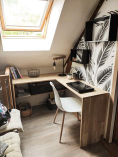 a room with a desk, chair and window in the corner on top of it