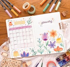 an open planner surrounded by crafting supplies