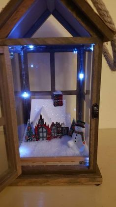 a snowman is in the window of a house with christmas lights on it's windowsill