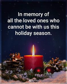 a red candle with the words in memory of all the loved ones who cannot be with us this holiday season