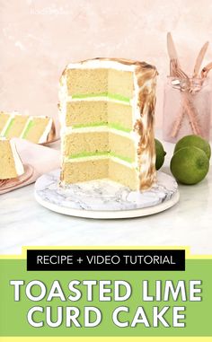 a slice of cake sitting on top of a white plate next to limes and other food