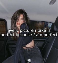 a woman sitting in the back seat of a car