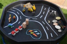 a play table with toys on it in the grass