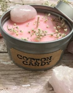 a pink candle sitting on top of a wooden table