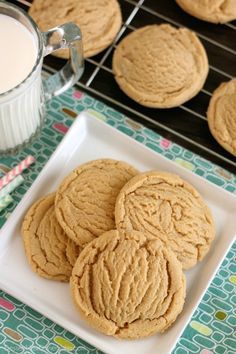 peanut butter cookies on a plate next to a glass of milk