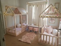 a room with three wooden beds and lights on the ceiling above them is a pink rug that says sweet home