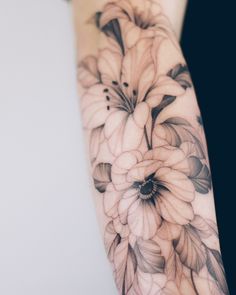 a woman's arm with flowers on it