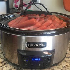 the crock pot is full of cooked carrots