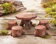 four wooden stumps sitting on the ground