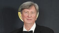 an older man in a tuxedo and bow tie