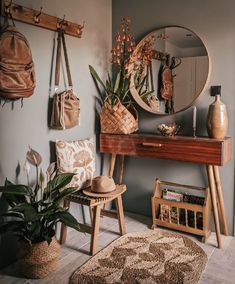 a room with a table, mirror and plants