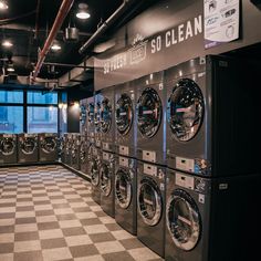 a row of washers and dryers in a laundry room