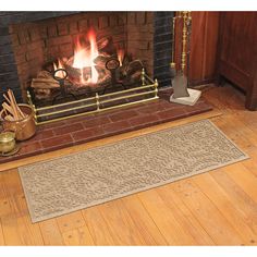 a living room with a fire place and rugs on the floor next to it