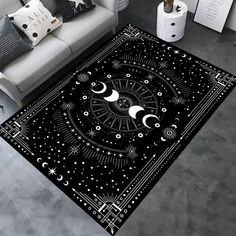 a living room area rug with an image of the moon and stars in black on it