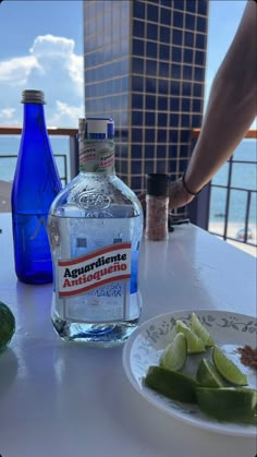 a bottle of water sitting on top of a table next to some sliced up vegetables