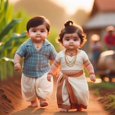 two small children walking down a dirt road