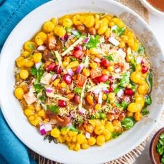 a white bowl filled with corn and vegetables