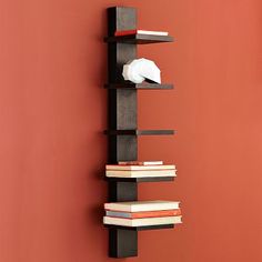 a bookshelf made out of black wood and white paper