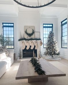 a living room filled with furniture and a fire place next to a christmas decorated tree