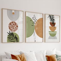 three art prints hanging on the wall above a couch