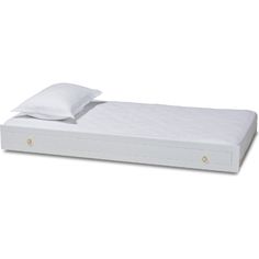 a white bed with two pillows on top of it and a pillow in the middle