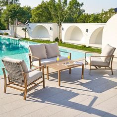 the patio furniture is by the swimming pool