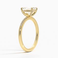 a yellow gold engagement ring with diamonds on it