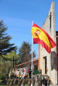 soldiers stand in front of a building with a flag on it