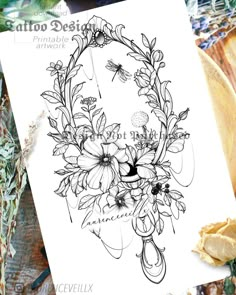 a drawing of flowers on paper next to some bread and buttersticks in front of it