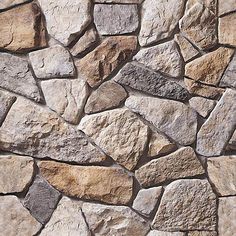 a stone wall that is made out of various types of rocks