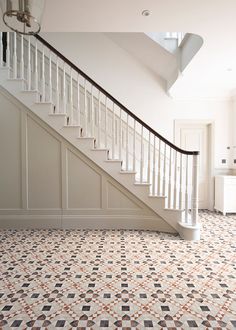 a white staircase with tiled flooring and handrails