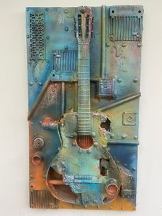 a metal sculpture with a guitar on it