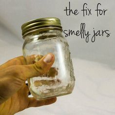 a hand is holding a jar with sand in it that says fix for smellly jars