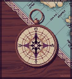 a cross - stitch pattern with a compass on it and a map in the background