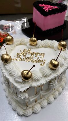 a heart shaped birthday cake sitting on top of a table