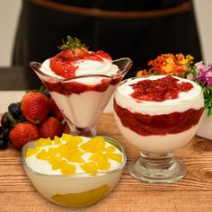 three desserts are arranged on a wooden table