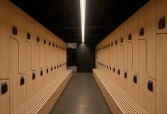 a long row of wooden benches sitting next to each other on top of a floor